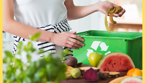 woman placing vegetable peels in recycling container